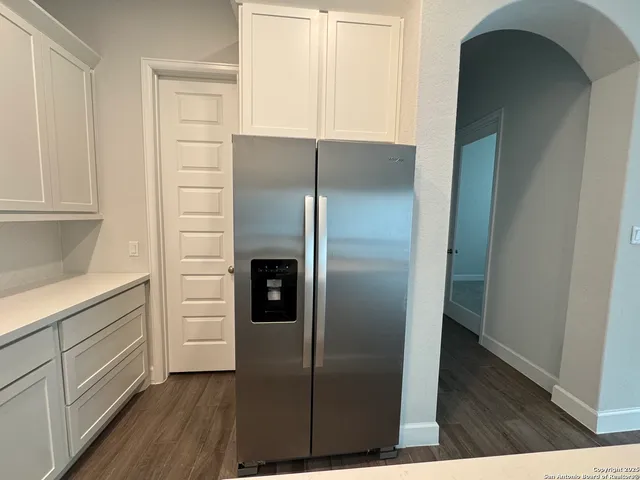 a kitchen with metallic refrigerator freezer and a dishwasher