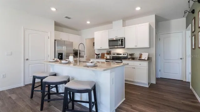 a kitchen with kitchen island a appliances and cabinets