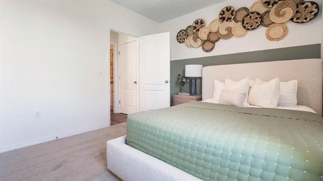 a bedroom with a bed and cabinets