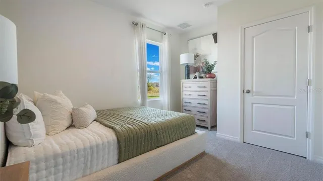 a bedroom with a bed and a cabinets