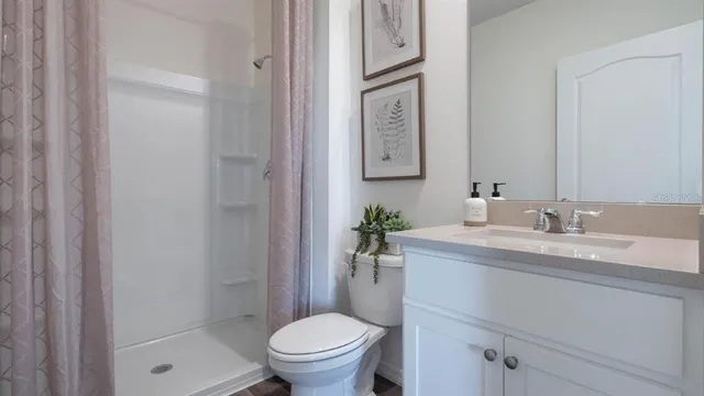 a bathroom with a granite countertop sink toilet and a mirror