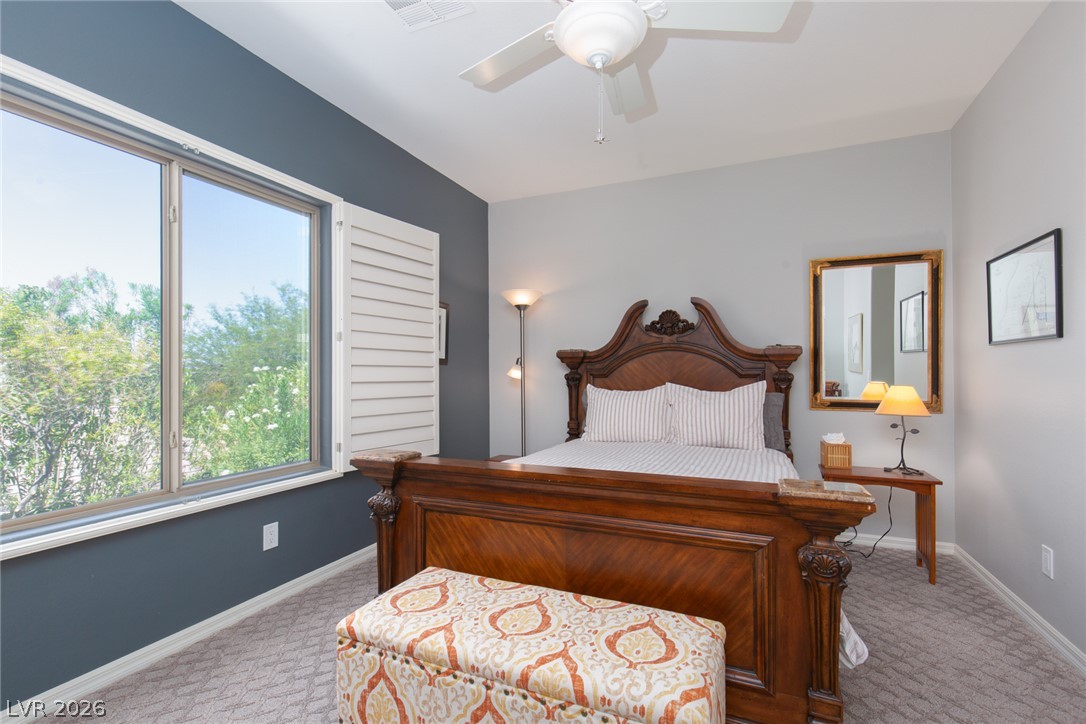 22 Douglas Grove Road Henderson, NV 89052 - Photo 56 of 72 A well-appointed bedroom features ample natural illumination from a large window with plantation shutters.