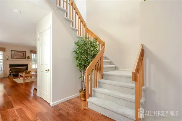 a view of entryway and hall with wooden floor