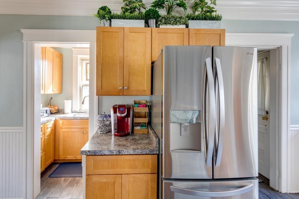 27 Hadwen Road Worcester, MA 01602 - Photo 13 of 27 a kitchen with kitchen island a counter top space and stainless steel appliances a refrigerator