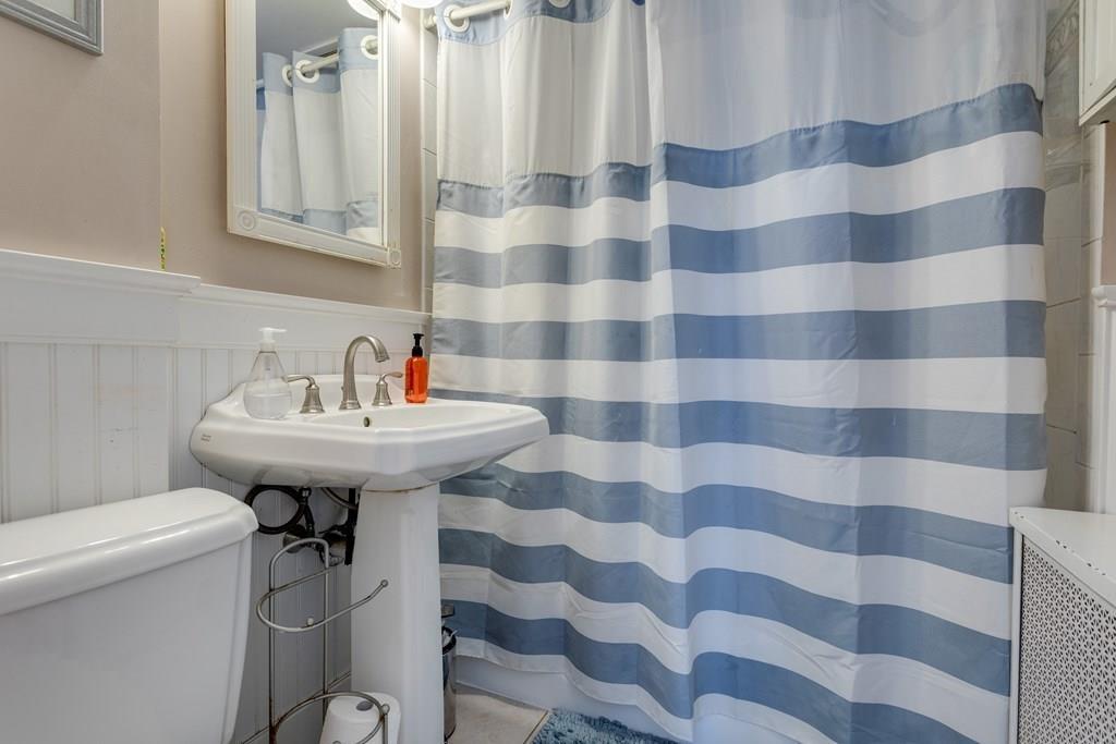 27 Hadwen Road Worcester, MA 01602 - Photo 17 of 27 a bathroom with a sink a toilet and mirror