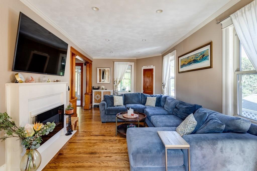 27 Hadwen Road Worcester, MA 01602 - Photo 8 of 27 a living room with furniture a flat screen tv and a fireplace