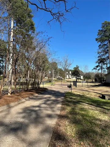 a view of yard with tree and and wooden fence