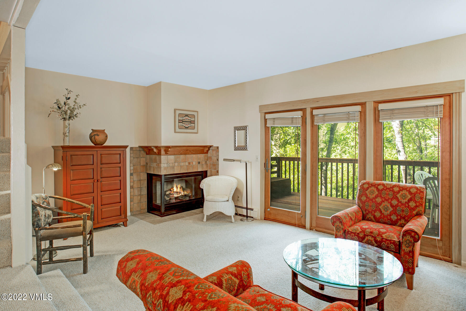 933 Red Sandstone Road, Unit 3 Vail, CO 81657 - Photo 1 of 15 a living room with furniture a fireplace and a large window