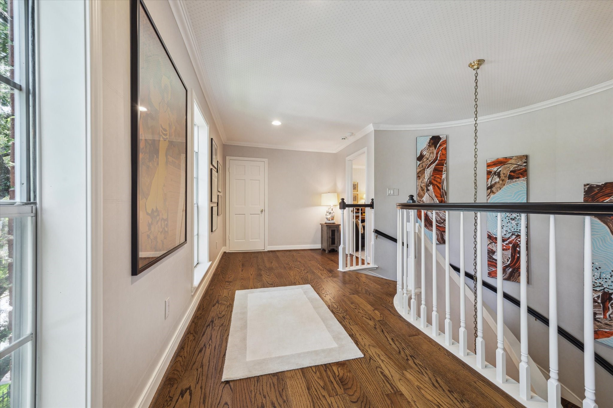2902 West Lane, Unit A Houston, TX 77027 - Photo 18 of 23 a view of a hallway with wooden floor and stairs