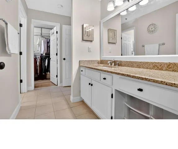 a bathroom with a sink a mirror and a shower