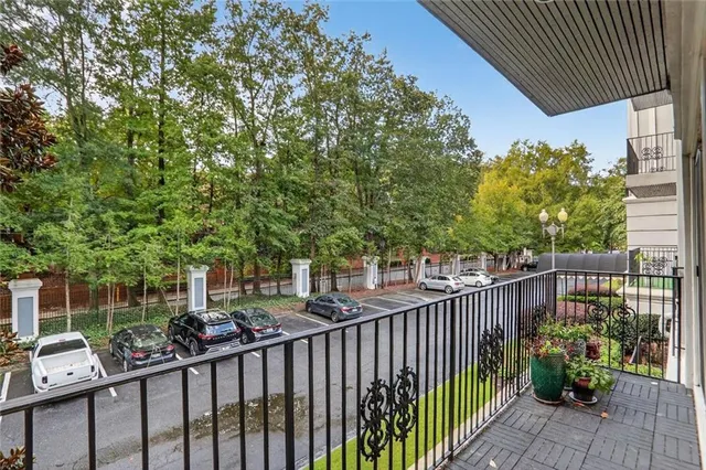 a view of a chair and tables in the balcony