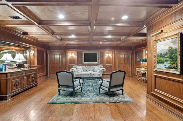 a dining room with wooden floor and furniture
