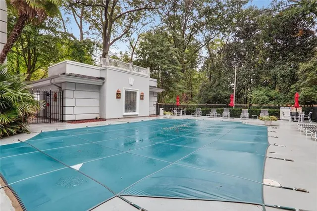 a view of a white house with a big yard and large trees