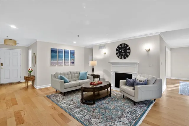 a living room with furniture a rug and a fireplace