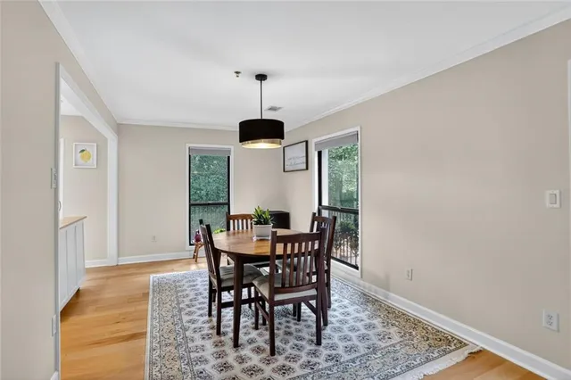 a view of a dining room with furniture and window