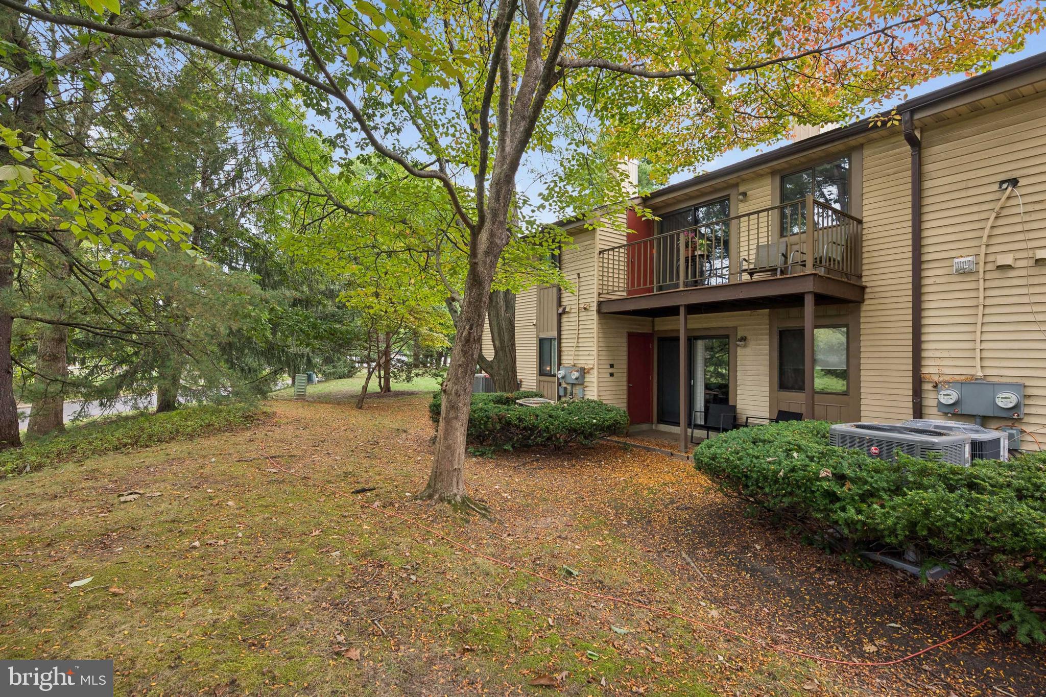 105 B Cypress Point Circle Mount Laurel, NJ 08054 - Photo 1 of 24 a view of a brick house with large windows and a large tree