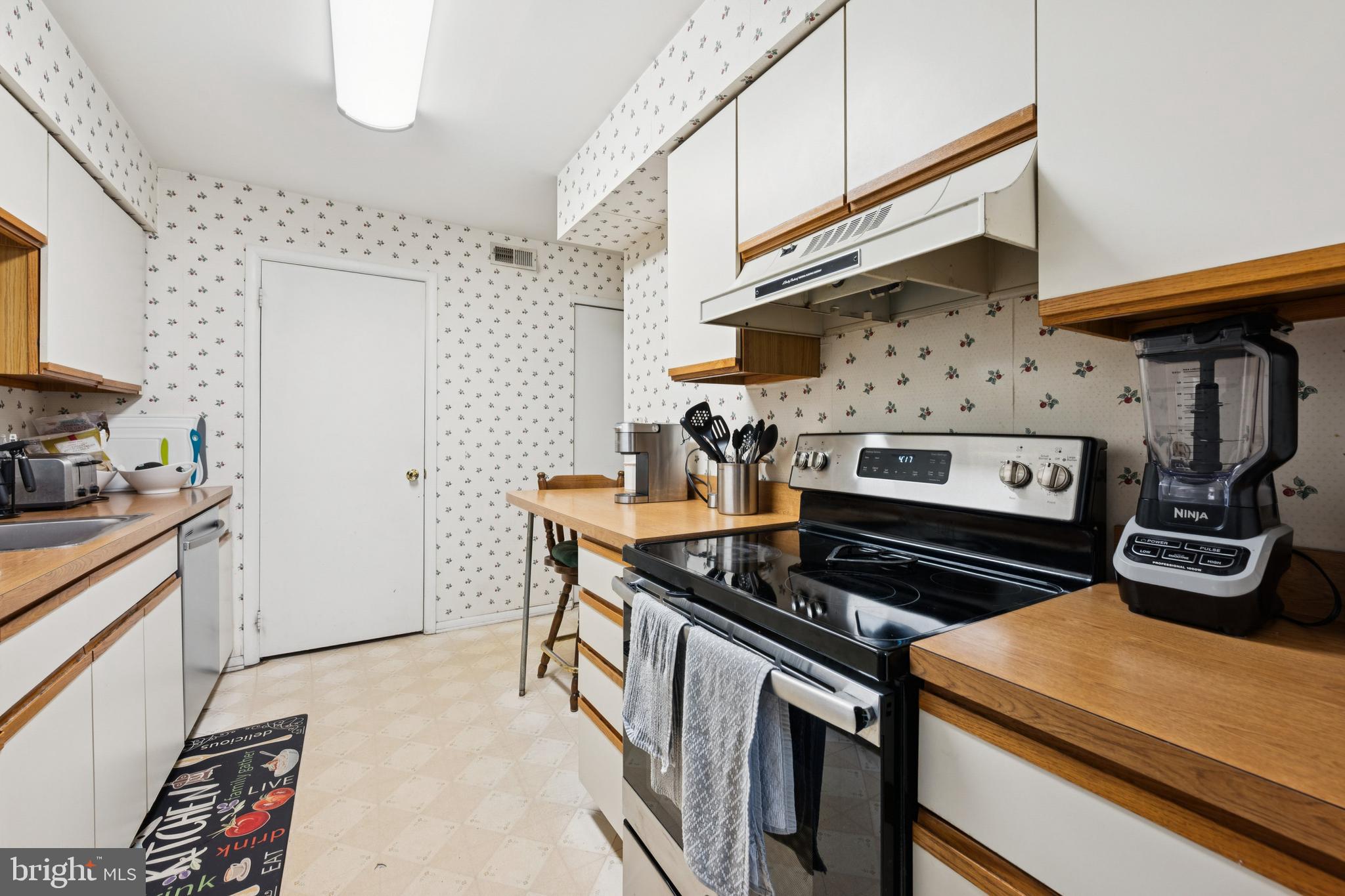 105 B Cypress Point Circle Mount Laurel, NJ 08054 - Photo 18 of 24 a kitchen with stainless steel appliances granite countertop a stove and a refrigerator