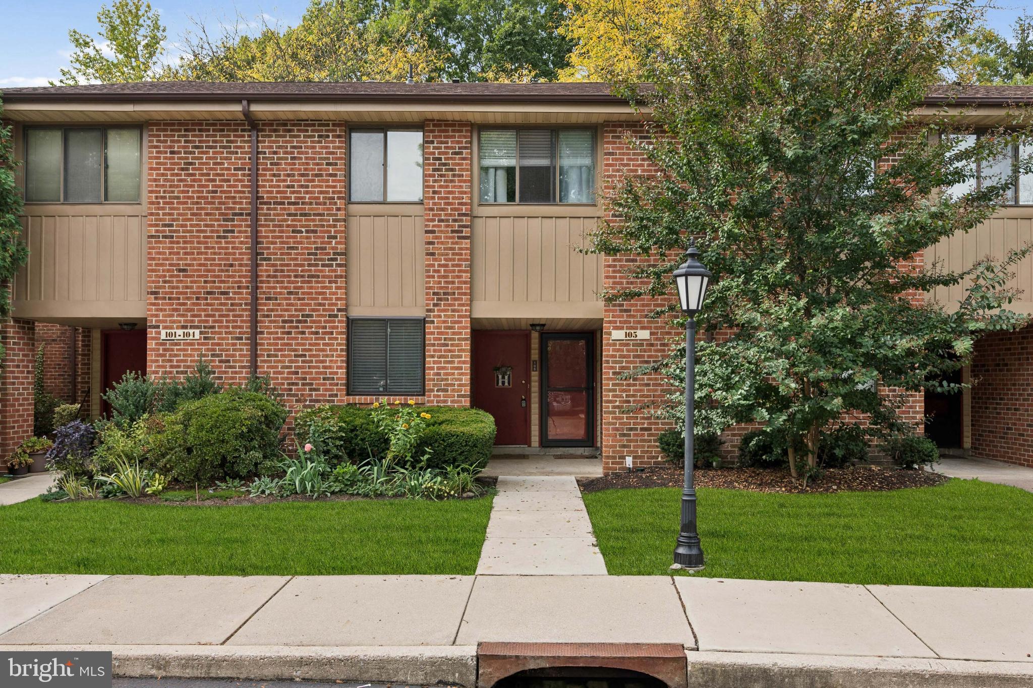 105 B Cypress Point Circle Mount Laurel, NJ 08054 - Photo 2 of 24 a front view of a house with a yard and a garage