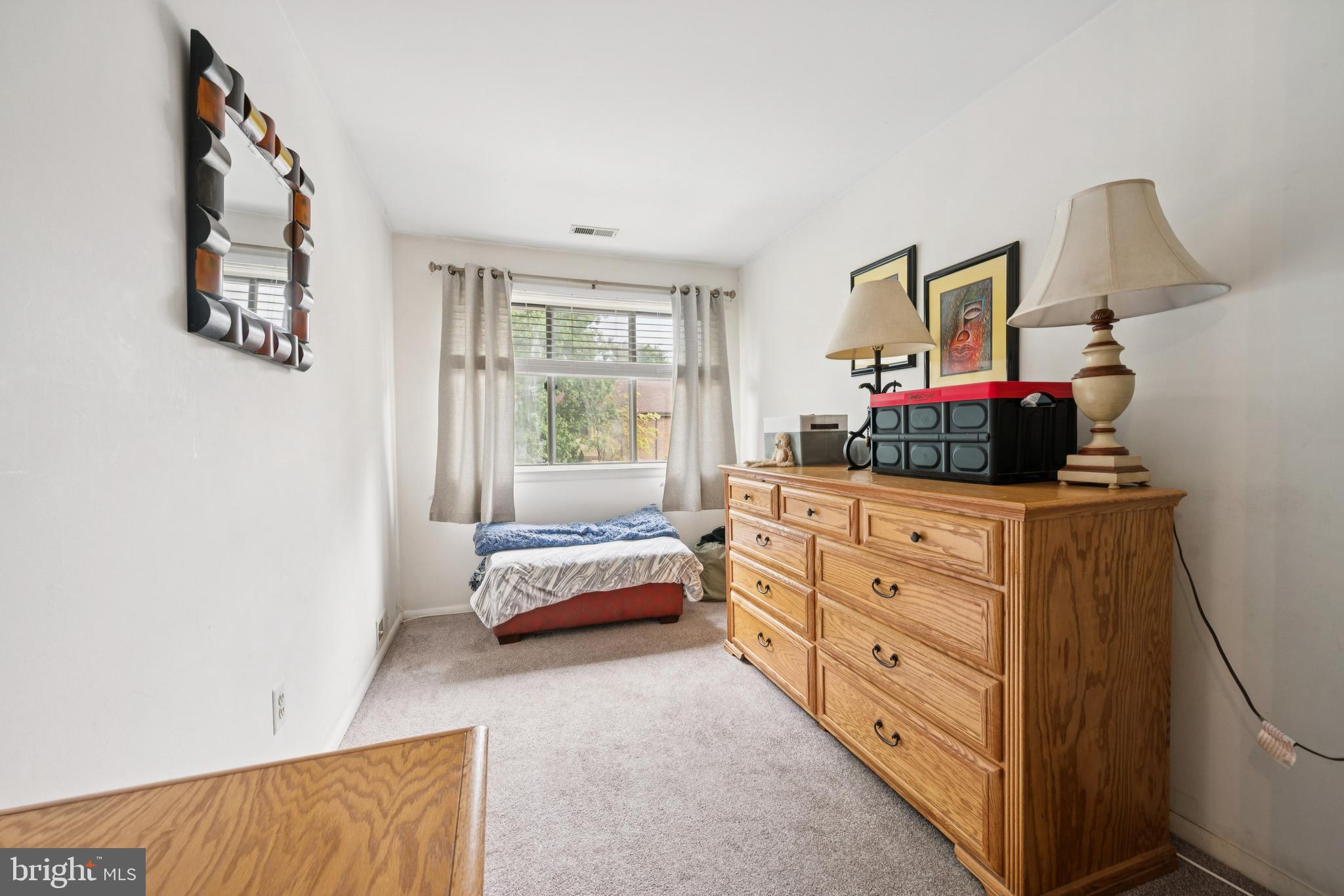 105 B Cypress Point Circle Mount Laurel, NJ 08054 - Photo 22 of 24 a bedroom with a bed and a dresser in it