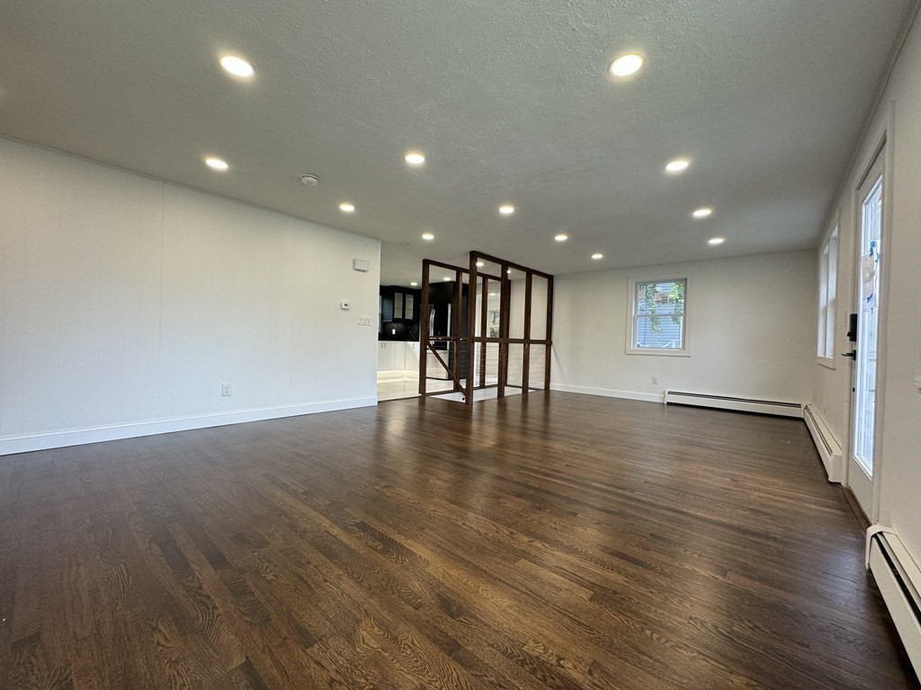 10 Proctor Street Worcester, MA 01606 - Photo 13 of 31 a view of an empty room with wooden floor and windows