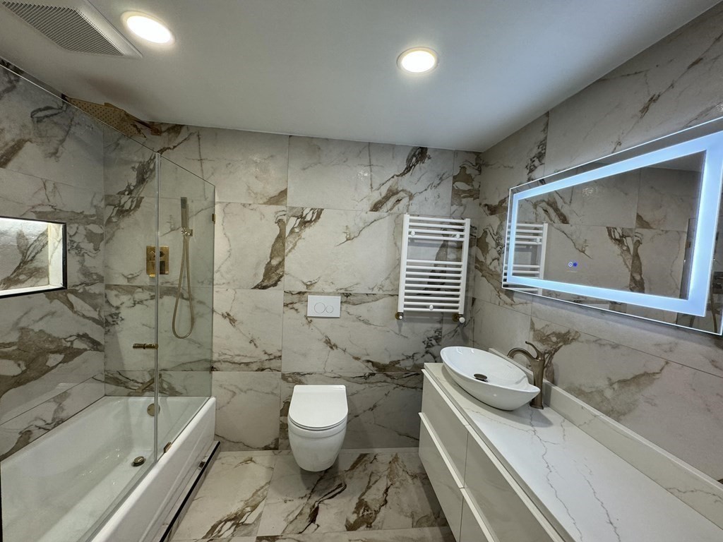 10 Proctor Street Worcester, MA 01606 - Photo 19 of 31 a bathroom with a sink toilet and shower