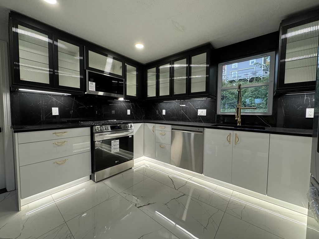 10 Proctor Street Worcester, MA 01606 - Photo 2 of 31 a kitchen with a sink and large window