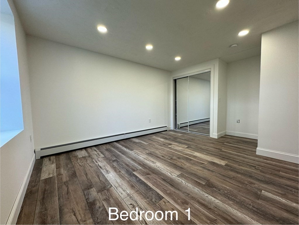 10 Proctor Street Worcester, MA 01606 - Photo 22 of 31 an empty room with wooden floor