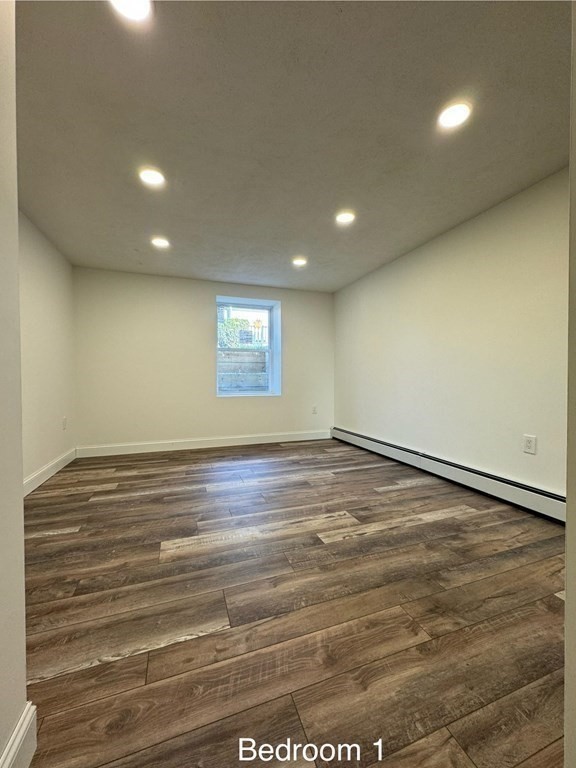 10 Proctor Street Worcester, MA 01606 - Photo 23 of 31 an empty room with wooden floor and windows