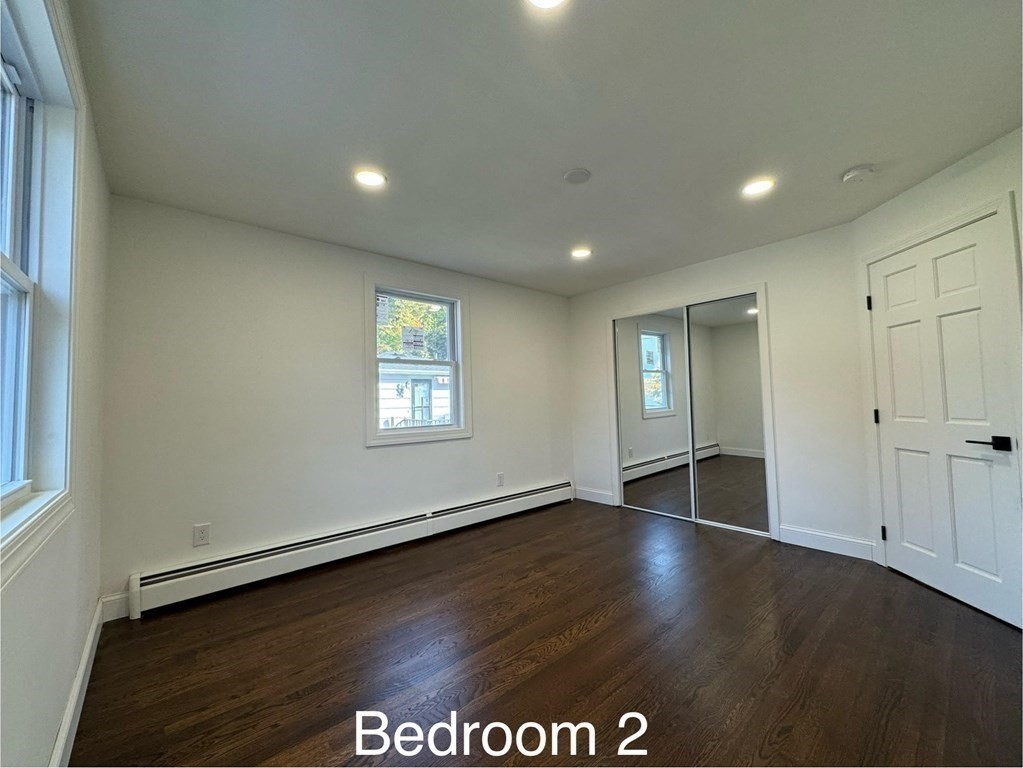 10 Proctor Street Worcester, MA 01606 - Photo 26 of 31 an empty room with wooden floor and windows