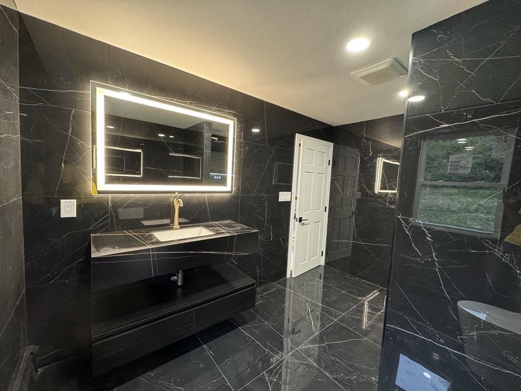 10 Proctor Street Worcester, MA 01606 - Photo 5 of 31 a bathroom with sink shower and mirror