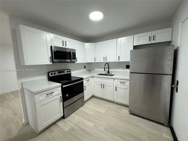 a kitchen with a refrigerator stove and microwave