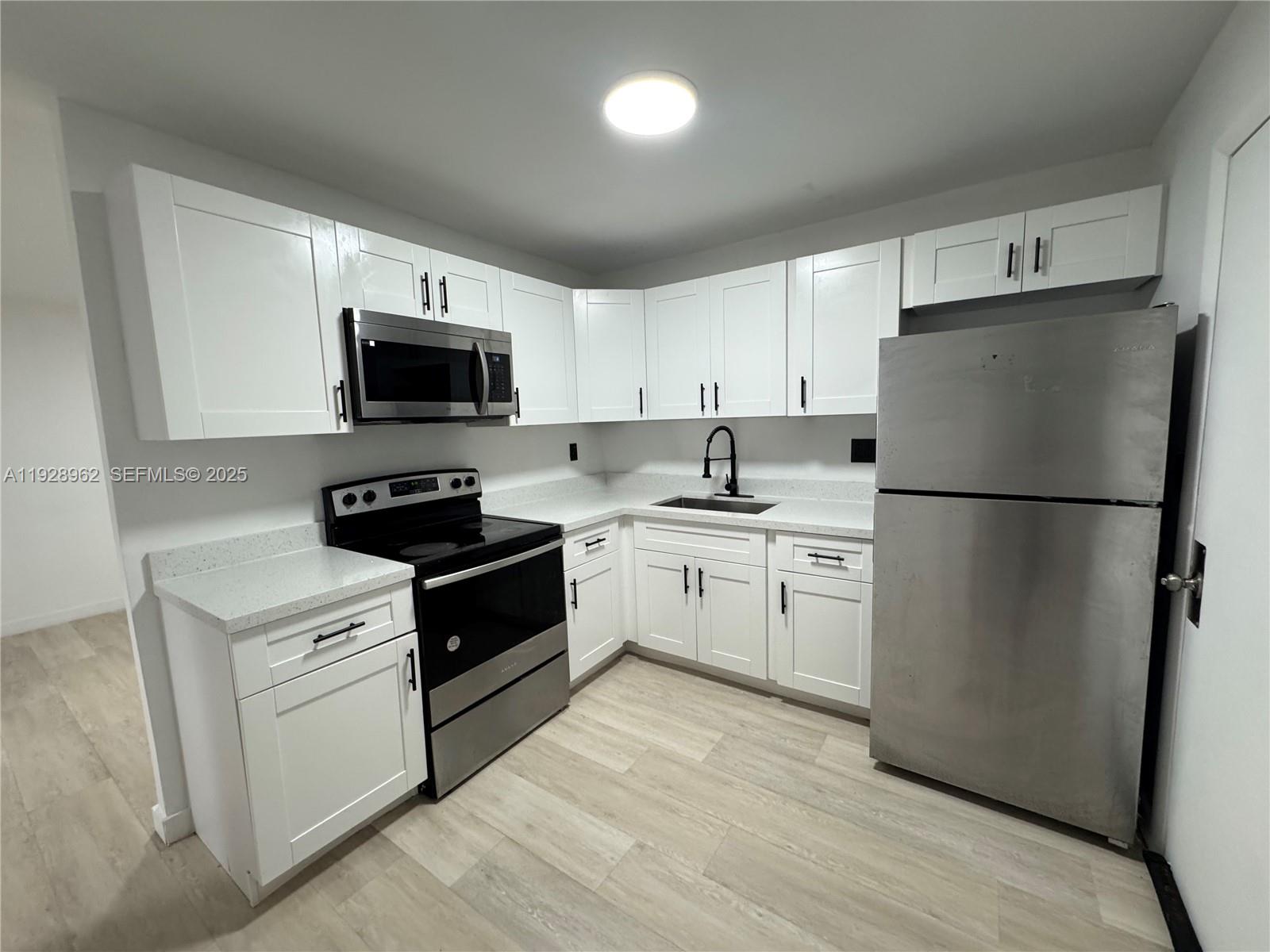 a kitchen with a refrigerator stove and microwave
