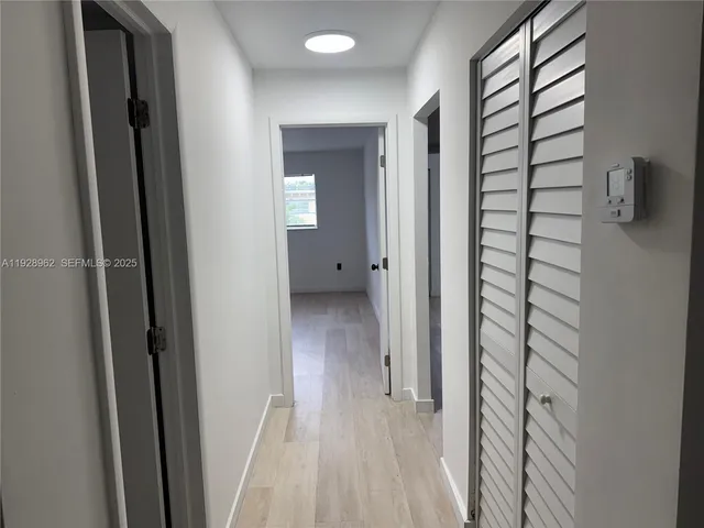 a view of a bathroom from a hallway