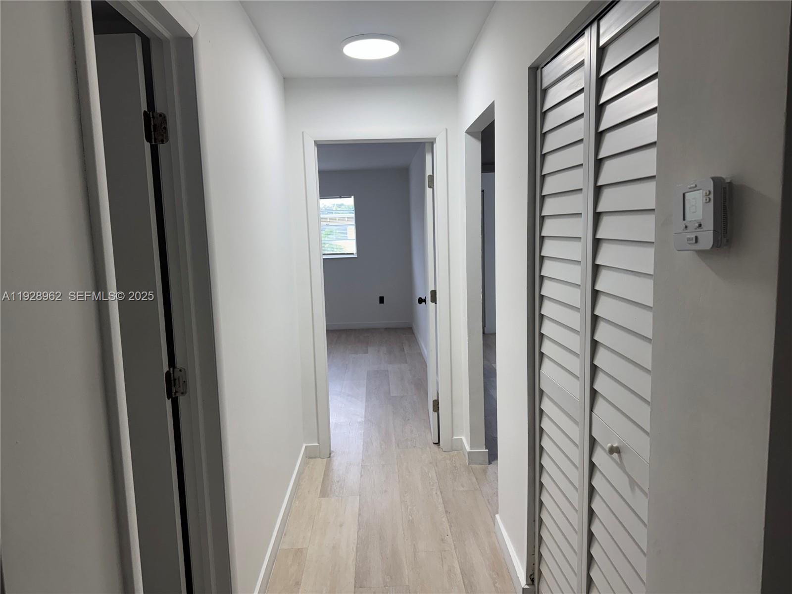 12215 West Dixie Highway, Unit 103 North Miami, FL 33161 - Photo 2 of 14 a view of a bathroom from a hallway