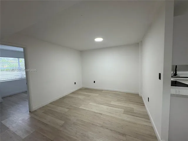 a view of an empty room and a window