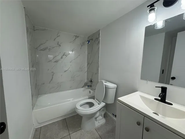 a bathroom with a sink a toilet and a bathtub
