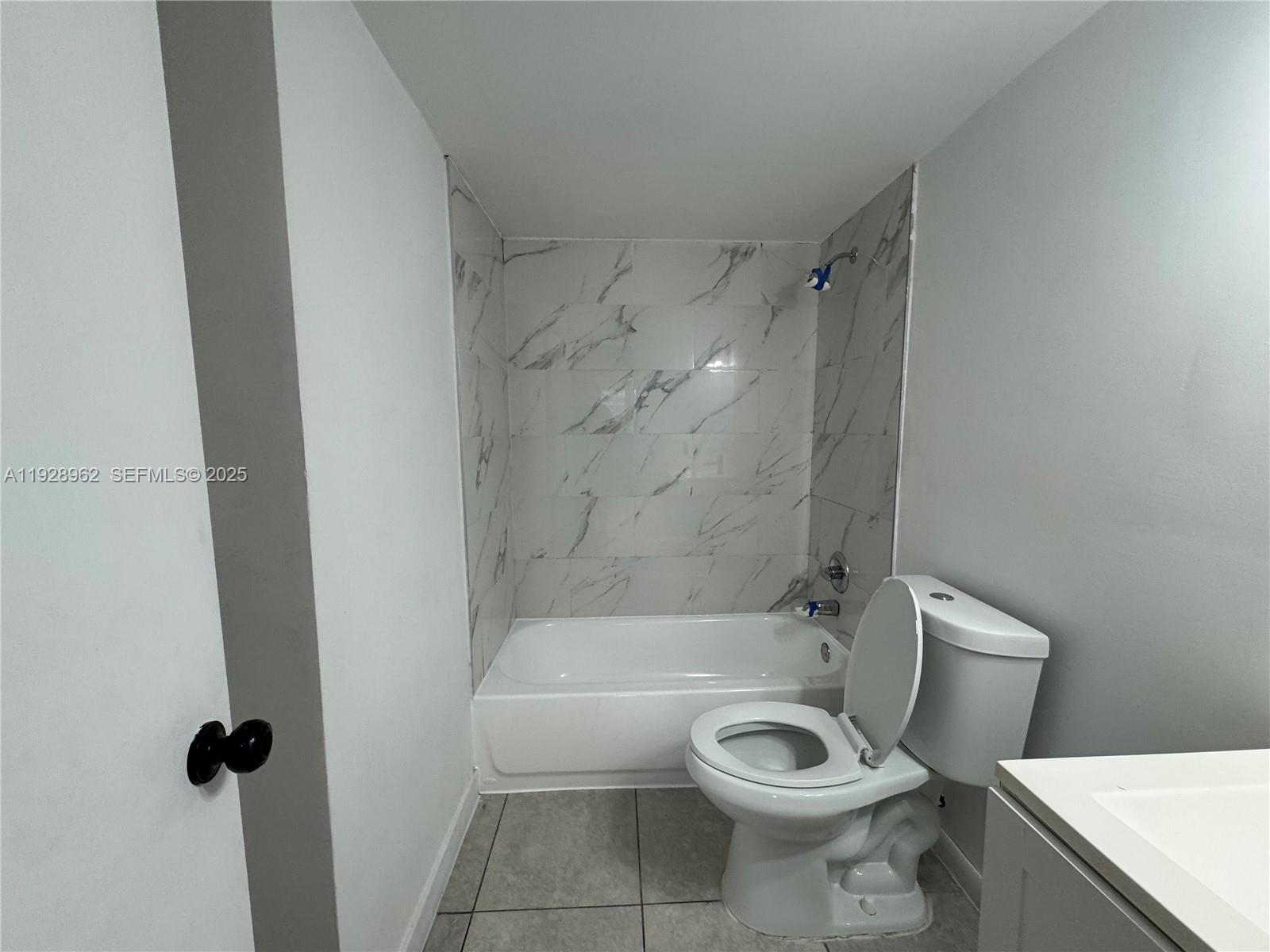 12215 West Dixie Highway, Unit 103 North Miami, FL 33161 - Photo 5 of 14 a bathroom with a toilet and a shower