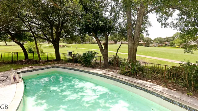 a view of swimming pool with a patio and yard