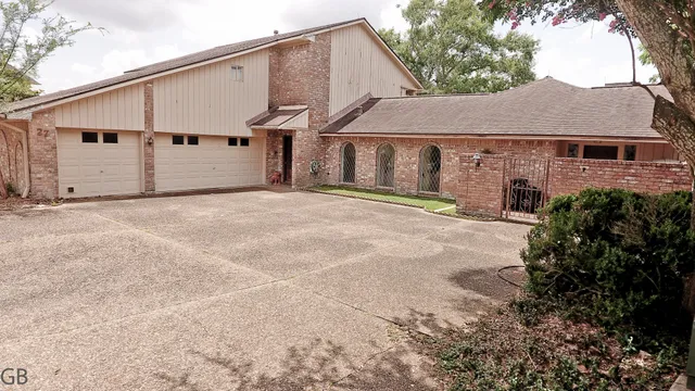 a view of a big house with a yard