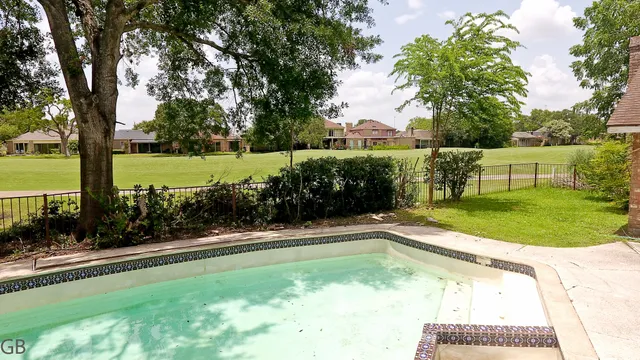 a view of a swimming pool and a yard