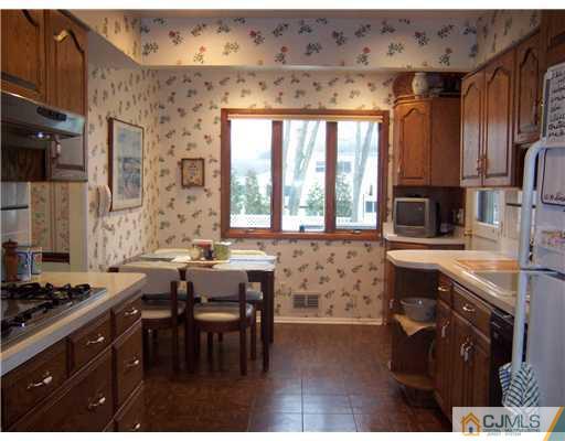 638 New Dover Road Colonia, NJ 07067 - Photo 2 of 23 a kitchen with stainless steel appliances granite countertop a stove a sink and a microwave