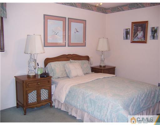 638 New Dover Road Colonia, NJ 07067 - Photo 12 of 23 a bedroom with a bed and a night stand