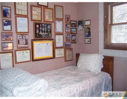 638 New Dover Road Colonia, NJ 07067 - Photo 15 of 23 a bedroom with a bed and a large window