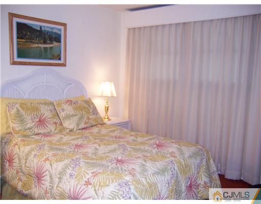 638 New Dover Road Colonia, NJ 07067 - Photo 17 of 23 a bedroom with a bed and a painting on the wall