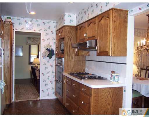 638 New Dover Road Colonia, NJ 07067 - Photo 3 of 23 a kitchen with stainless steel appliances granite countertop a refrigerator and a stove