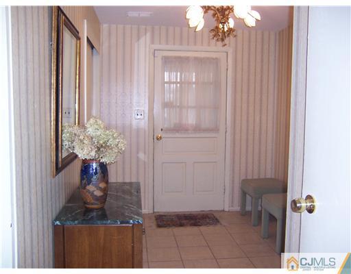 638 New Dover Road Colonia, NJ 07067 - Photo 21 of 23 a vase of flowers sitting on a table in a bathroom