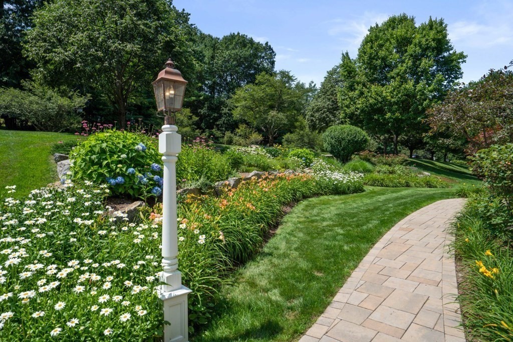22 Falcon Ridge Drive Hopkinton, MA 01748 - Photo 3 of 42 a front view of a house with a yard and fountain in middle