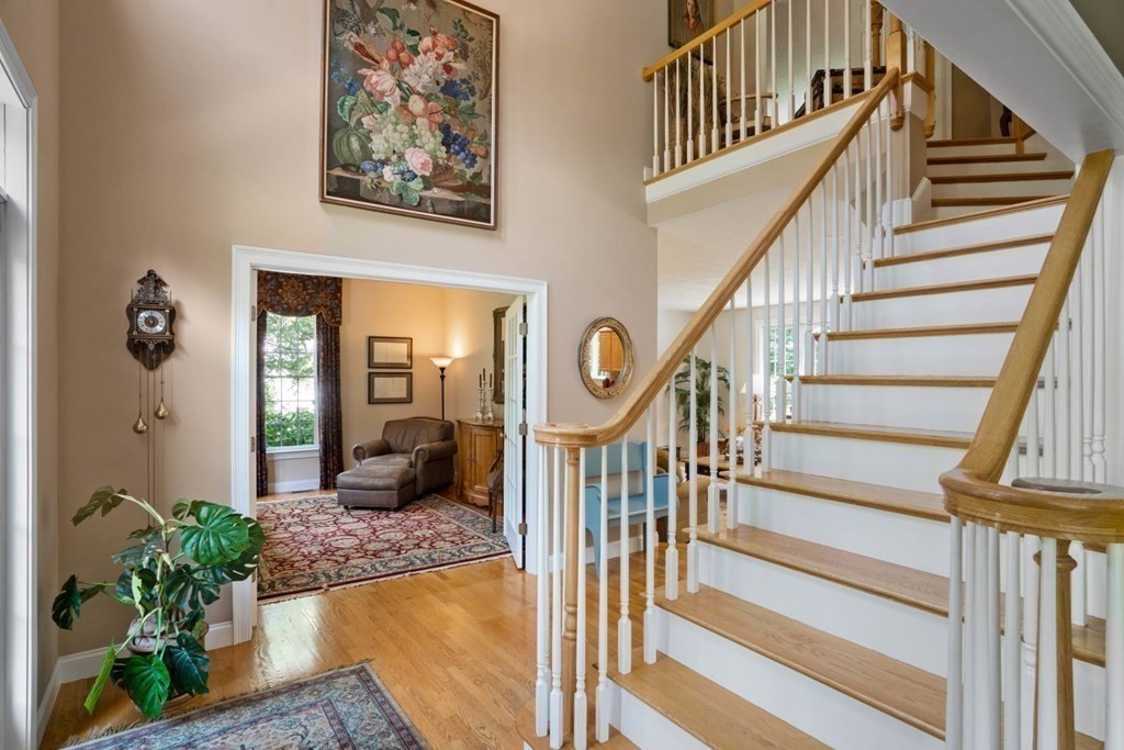 22 Falcon Ridge Drive Hopkinton, MA 01748 - Photo 5 of 42 a view of staircase with wooden floor and a rug
