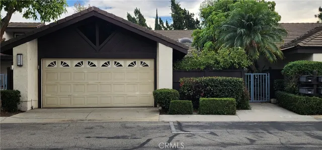 a view of a house with a door and a yard