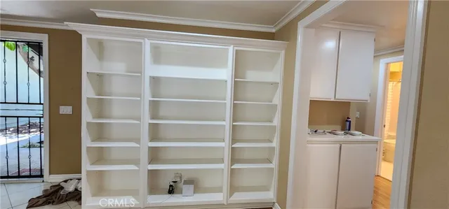 a view of empty room with wooden floor and fireplace